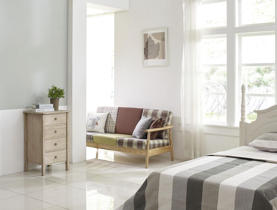 Sunny bedroom with white walls and tall windows