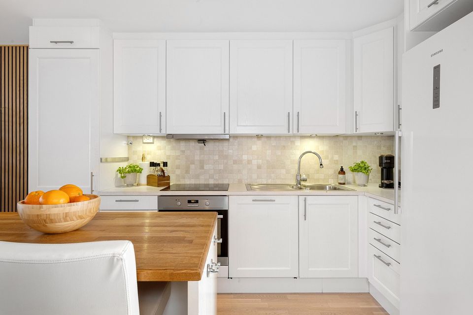 Bright kitchen with smooth white painted cabinets